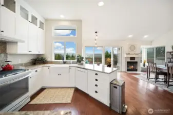 A stylish farmhouse sink elevates the kitchen, which flows effortlessly into a cozy dining nook and relaxed family room.