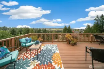 The expansive Trex deck features a remote-controlled awning, perfect for year-round enjoyment.