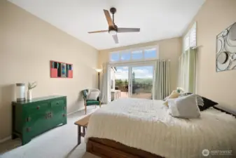 Returning to the expansive primary bedroom, enjoy the view toward the deck access, inviting the outdoors in.