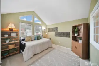 Versatile guest room, perfect as a craft room or den, features a window overlooking the living and kitchen area, complete with a shade for privacy.