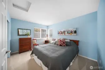 One of the two upstairs guest rooms welcomes you with its generous space and inviting ambiance.