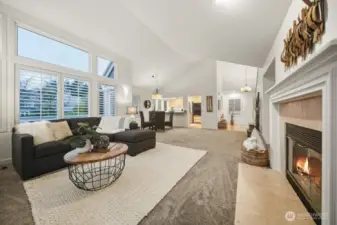 Returning to the great room, this breathtaking perspective highlights soaring cathedral ceilings that infuse the space with dramatic dimension and captivating architectural interest.