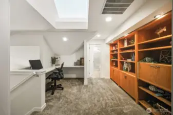 The dedicated upstairs office overlooks the grand great room below, with generous space for two workstations. Rich built-ins infuse the room with timeless character and inviting ambiance.