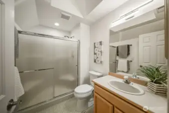 The dedicated upstairs guest bathroom glows with natural light pouring through a generous skylight, inviting the outdoors in. Just to the left of the door (not pictured) lies a spacious bonus storage area, perfect for linens, luggage, or seasonal treasures!