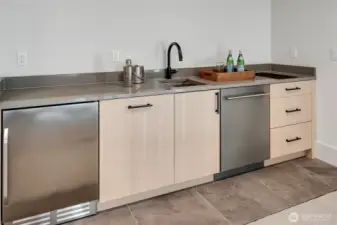 Efficient kitchen in the ADU with cooktop, dishwasher, fridge and sink.