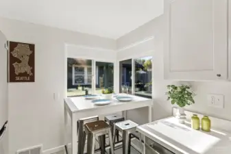 Just off the living room, the kitchen offers a bright corner eating space with natural light from multiple windows.