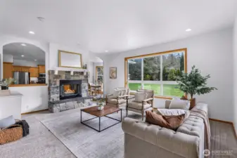 Spacious and light-filled living room with central fireplace