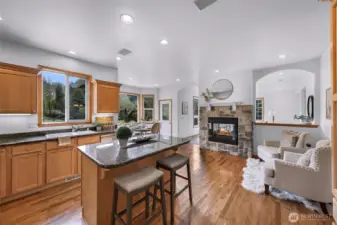 Keep the chef company in the kitchen at the bar or near the warmth of the central fireplace