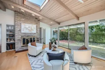 This charming family room with its own statement fireplace and a view of the private courtyard all in bloom