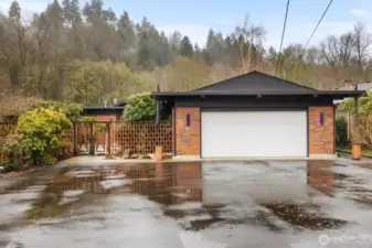 Spacious driveway offers ample parking, complementing the attached two-car garage.