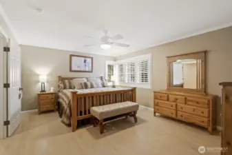 Spacious primary suite with ceiling fan