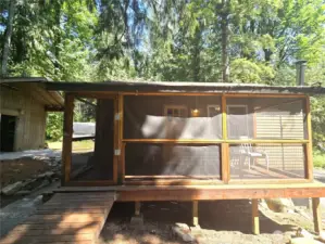 Very convenient covered and screened front porch. Gently sloping ramp allows you to avoid any steps.