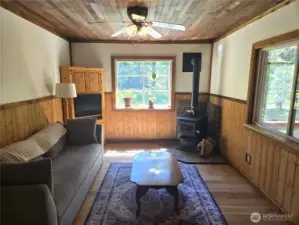 Living room has lots of windows, bringing in extra light. Notice the great custom woodwork.