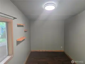 The second bedroom has new flooring and custom shelving.