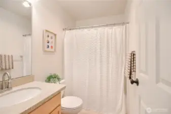 Full bathroom with granite countertops and   brushed stainless steel faucet.