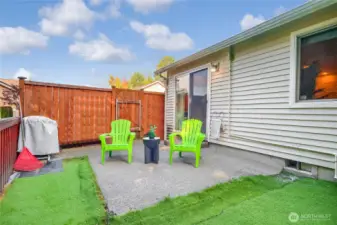 Private backyard has some no maintenance turf.