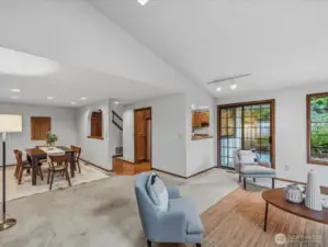 View from living room towards dining room on the left, sliding glass door to the peaceful backyard