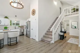 Beautiful open floor plan with high vaulted ceilings, durable vinyl plank floors.