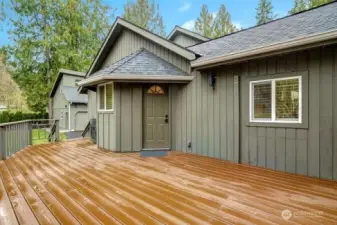 Entertainment size deck on side of home adjacent to new patio & fire pit and beautiful yard next to creek