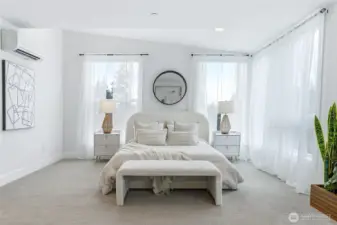 Sumptuous primary suite with walls of windows. Additional sitting area