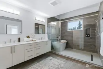 Gorgeous Primary bathroom with soaking tub and heated floors & tile wrapped walls