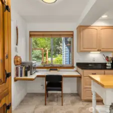 The kitchen includes a thoughtfully designed desk nook.