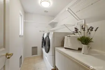 Main floor laundry room with lots of counter and storage space.
