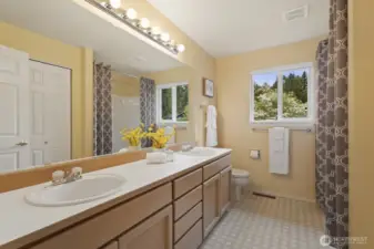 Upstairs hall bath has dual vanities, soaking tub, and shower.