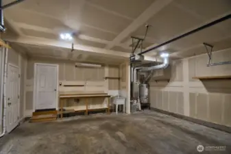 Useful utility sink in garage, work bench and shelving