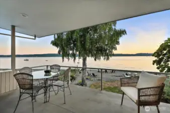 Primary deck blends horizon and sea, offering sweeping sandy beach views framed by vibrant sunsets. A coastal retreat where sky meets shoreline in nightly brilliance.