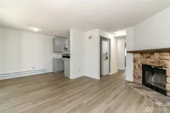 Living Room with Wood Burning Fireplace, Dining Room and Hallway