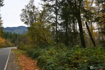 The property lies adjacent to Ley Road ~ with a mountain backdrop in the distance.
