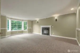 Bright living room with fireplace and oversized windows
