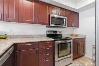 Kitchen Featuring Granite Countertops & Electric Stove