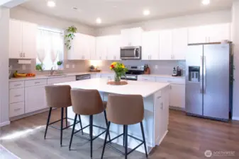 View of kitchen with large island with quarts zounter tops