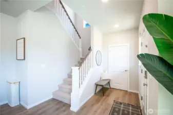 View of the entry way with coat closet and stairs.