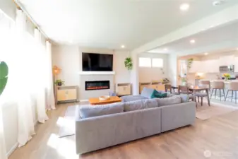 View of the living room from the front entryway looking into the dinning room and kitchen off to the side.