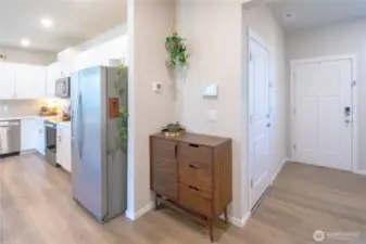 View of the kitchen off to the left as well as garage door and back door off to the right next to the mudroom area.