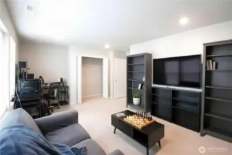 Spacious and versatile! This oversized 4th bedroom is currently staged as a multimedia room but offers endless flexibility as a home office, gym, or play space.