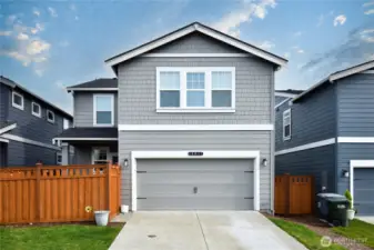 Back of home with 2 car garage access and 2 car driveway.