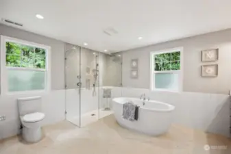Newly remodeled primary ensuite! Replete with heated floors, custom cabinet, quartz counters, new shower with wet wall.