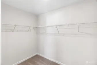 Primary bedroom walk in closet