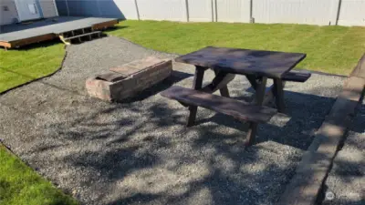 Rear yard with fireplace and picnic table