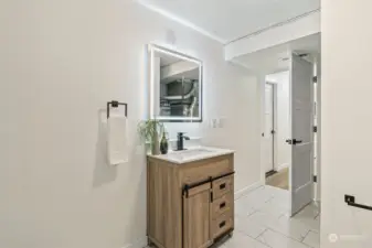 Lower level bathroom sink with LED mirror