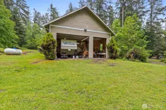 Attached shop on west side of house, large enough for 4 standard sized vehicles or boat/rv parking.
