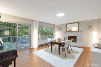 Dining room area with fireplace. Add additional seating to relax and access to deck.