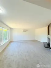 Bright and cozy living room with a wood-burning fireplace.