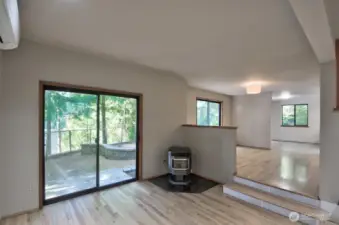 Living room with pellet stove and sliders to the back yard.
