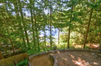 View of back yard and lake from deck off of primary bedroom.