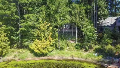 Drone view of the back of the house and lower deck from the lake area.